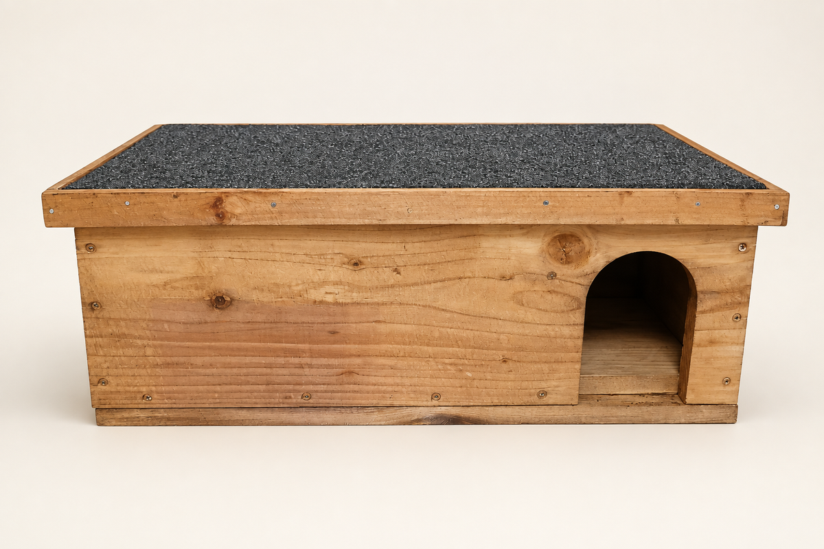 Front of wooden hedgehog house with arched entrance and felt roof