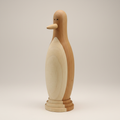 Handcrafted hand-turned wooden penguin sculpture showing wood grain and artisan detail